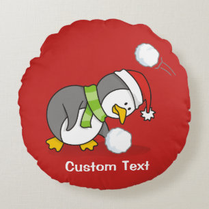 Christmas penguin getting a snow ball round cushion