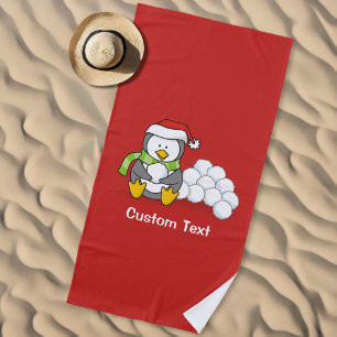 Christmas penguin sitting with snow balls beach towel