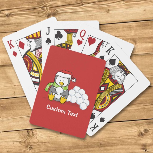 Christmas penguin sitting with snow balls playing cards (Creator Uploaded)