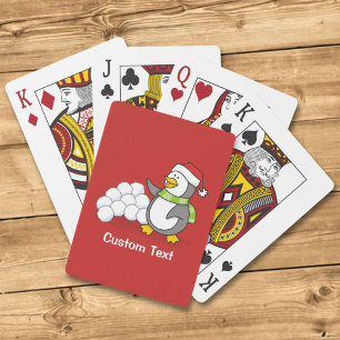 Christmas penguin with snow balls waving playing cards