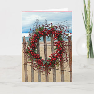 Christmas red berry wreath on beach fence holiday card