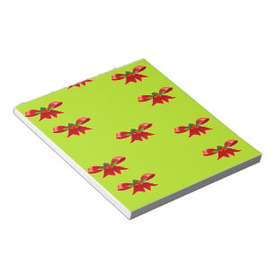 Christmas red ribbon on bright green notepad