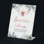 Christmas Red Santa Baby Shower Bottle Chug Sign<br><div class="desc">The Red Santa Gender Neutral Santa Baby Clothes Christmas Santa Baby Bottle Chug Sign brings a festive and playful touch to your baby shower without needing a red background. Featuring delicate snowflakes, eucalyptus greenery, and adorable Santa-inspired baby clothes, this sign invites guests to participate in the “Bottle Chug” game. It’s...</div>