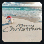 Christmas Sand Man On a Beach Square Sticker<br><div class="desc">A small sand snowman wearing a Santa hat stands on an ocean beach with "Merry Christmas" written in the sand</div>