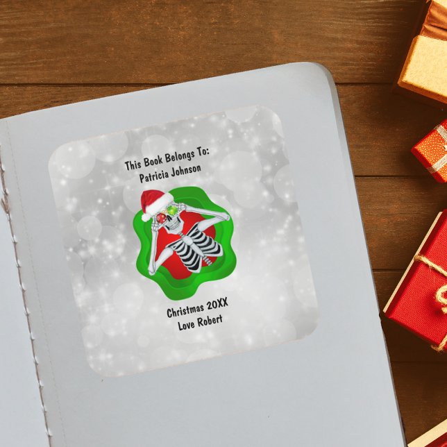 Christmas Skeleton Ornaments Bright Red Green  Square Sticker (Cute Skeleton holding ornaments for eyes Santa Hat in green Red splatter on white book plate sticker)