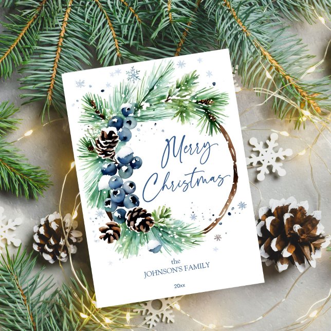 Christmas watercolor snowy pines wreath holiday card (Merry Christmas template holiday greeting card watercolor pine wreath blue winter berries pinecones)