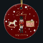 Christmas Whimsical Nutcracker Santa Kids Name Ceramic Ornament<br><div class="desc">This whimsical red Christmas tree bauble design features a Children's Nutcracker scene complete with a rocking horse, drum set and toy soldier on the front with rocking horse and faux Gold foil Merry Christmas on the back. This luxury kids personalized Christmas tree decoration is complete with a gold rustic script...</div>