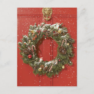 Christmas wreath hanging on a door holiday postcard