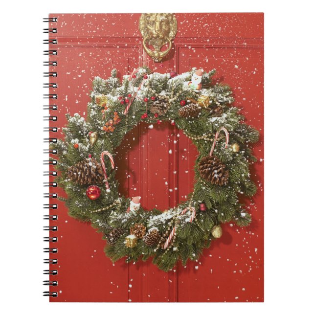 Christmas wreath hanging on a door notebook (Front)