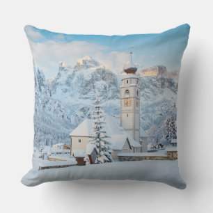 Church covered in snow with mountain background cushion