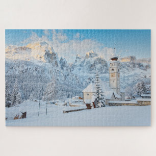 Church covered in snow with mountain background jigsaw puzzle