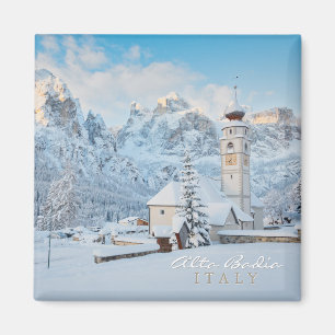 Church covered in snow with mountain background magnet