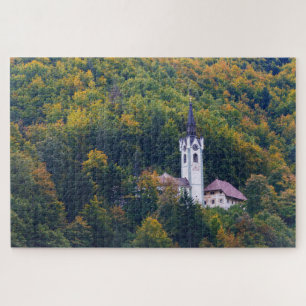Church in a fall forest in Slovenia Jigsaw Puzzle