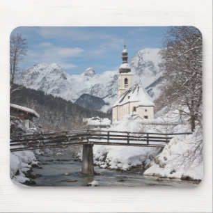 Church in the snow with Alps mountains in winter Mouse Pad