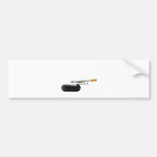 Cigarette on ashtray over white bumper sticker