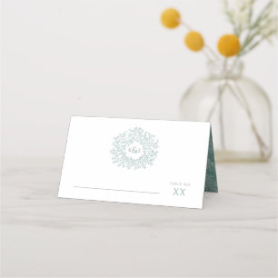 Circle of green leaves drawing monogram wedding place card