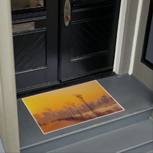 Cityscape at sunset doormat