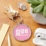 Class Of  Keychain<br><div class="desc">Grad class keychain is shown in a pink and white color design.
Text: Class of 2026.



Licensed</div>