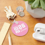 Class Of  Keychain<br><div class="desc">Grad class keychain is shown in a pink and white color design.
Text: Class of 2026.



Licensed</div>