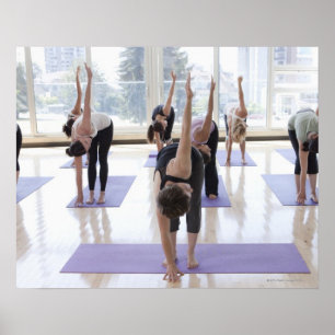 class practicing yoga with instructor in a poster