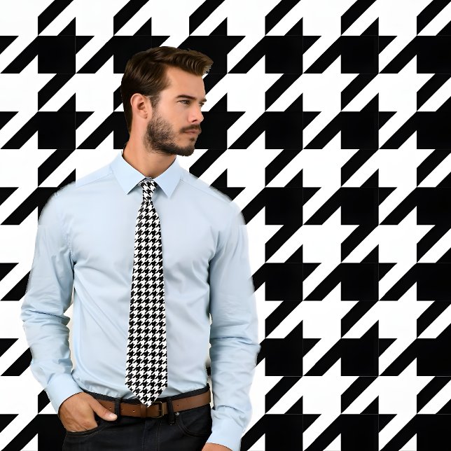 Classic Black and White Houndstooth Check Tie (Man wearing black and white houndstooth pattern necktie. He stands against wall with same pattern.)