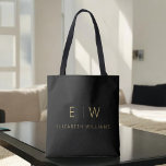 Classic Black Gold Minimalist Monogram Name Tote Bag<br><div class="desc">Elevate your style with our Classic Elegant Modern Minimalist Monogram Tote Bag. This versatile tote seamlessly blends timeless sophistication with contemporary minimalism, making it an essential accessory for any occasion. Designed with meticulous attention to detail, this tote bag is more than just a practical accessory; it's a personalised fashion statement....</div>
