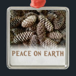 Classic Holiday Pine Cone Peace On Earth Metal Ornament<br><div class="desc">Festive, earthy pine cones set off this classic, elegant design wishing Peace On Earth.</div>