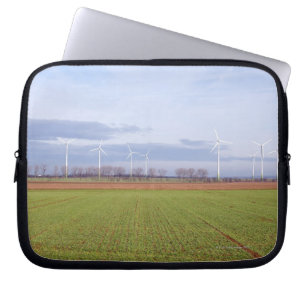 Clean energy by many wind turbines on fields. laptop sleeve