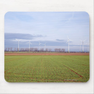 Clean energy by many wind turbines on fields. mouse pad