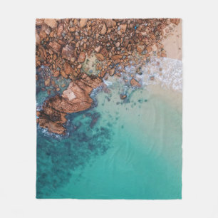 Clear blue sea and rocks fleece blanket