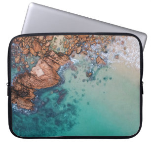 Clear blue sea and rocks laptop sleeve