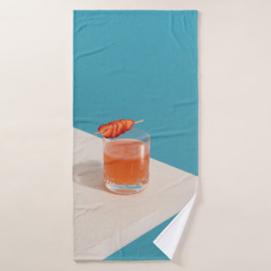 Clear drinking glass with brown liquid bath towel