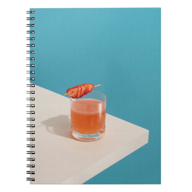 Clear drinking glass with brown liquid notebook (Front)