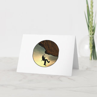 Climbing mountain man at sunset card