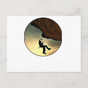Climbing mountain man at sunset postcard