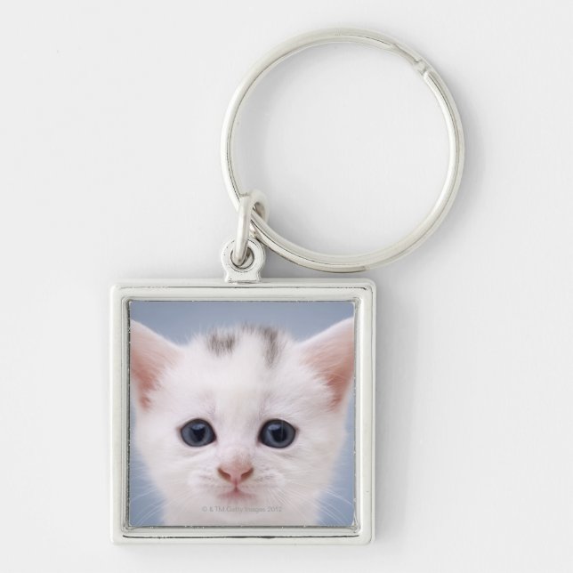 Close up image of a predominately white faced key ring (Front)
