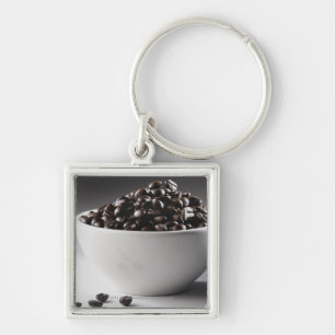 Close-up of a bowl full of coffee beans key ring