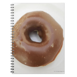 Close-up of a chocolate doughnut on a plate notebook