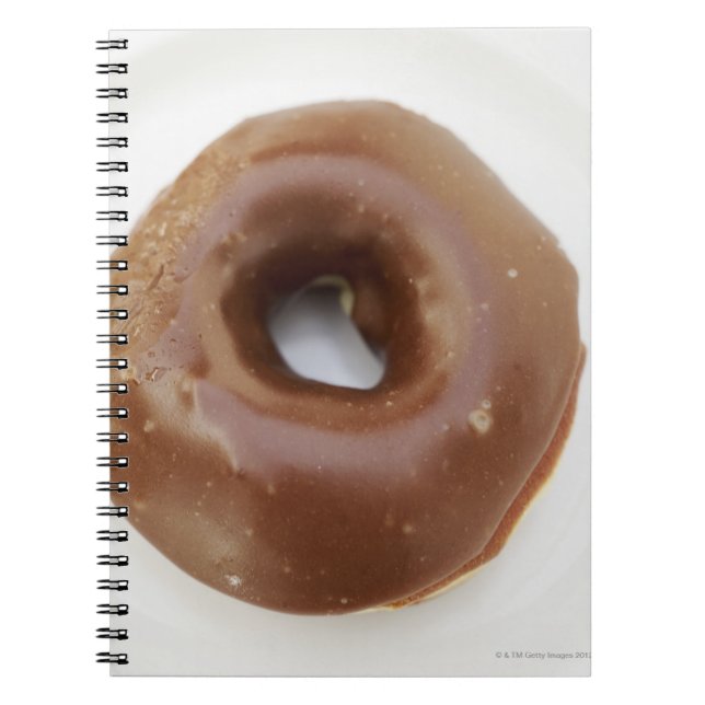 Close-up of a chocolate doughnut on a plate notebook (Front)