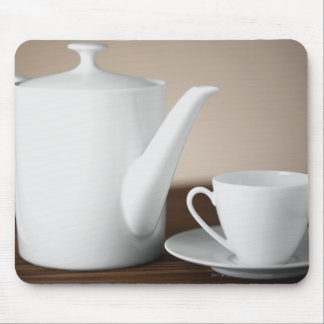 Close-up of a cup and a saucer with a tea kettle mouse pad