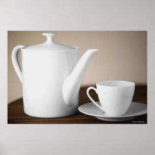 Close-up of a cup and a saucer with a tea kettle poster