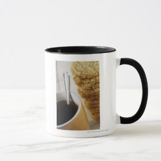 Close-up of a cup of coffee with cookies