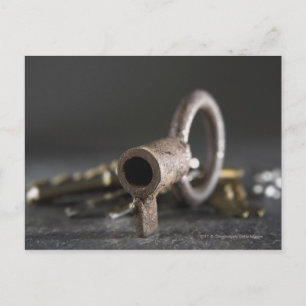 Close-up of a key in a key ring postcard