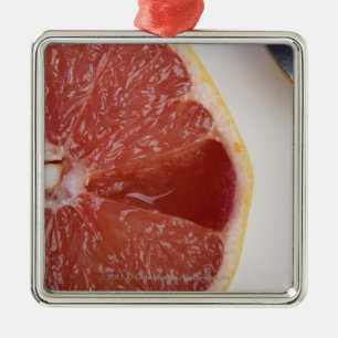 Close-up of a slice of orange and a spoon metal ornament