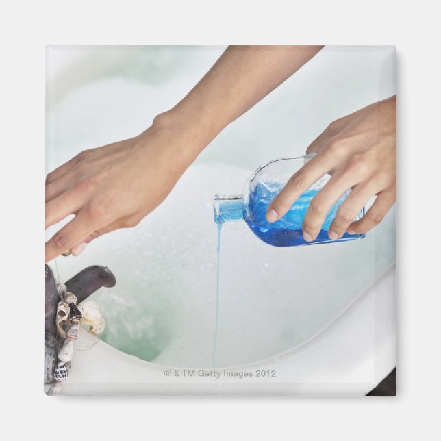 Close-up of a woman's hand pouring aromatherapy magnet (Front)