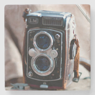 Close-up of an antique camera stone coaster