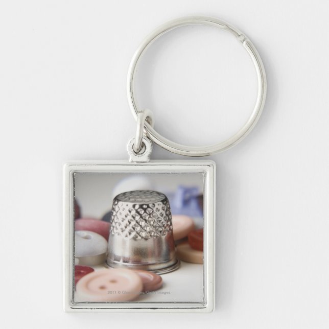 Close-up of buttons with a metal cap key ring (Front)