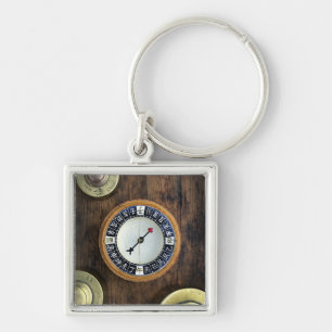 Close Up Of Chinese Compass And Gold Weights Key Ring