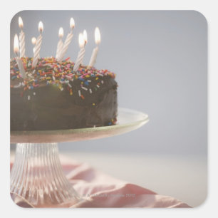 Close up of chocolate birthday cake with candles square sticker