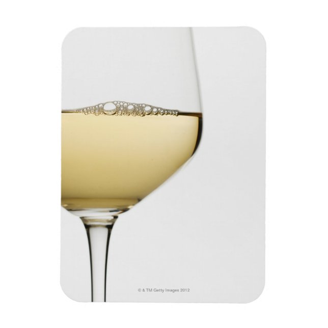 Close up of glass of white wine on white magnet (Vertical)